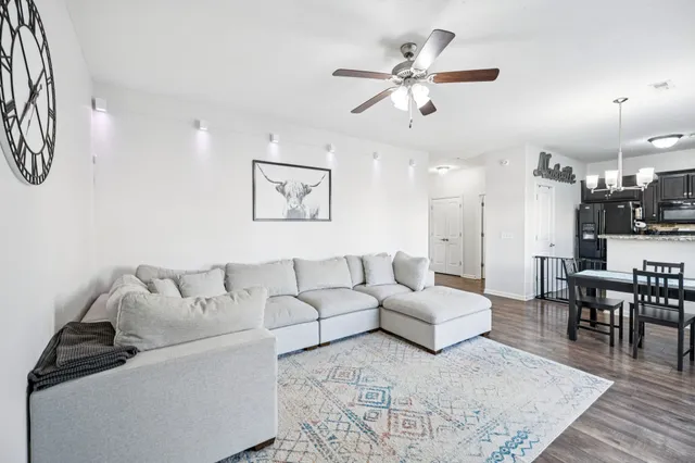 a living room with furniture and a chandelier