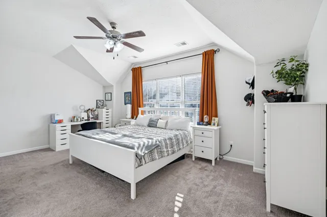 a room with a bed and a chandelier