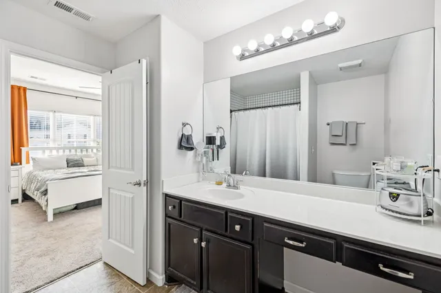 a bathroom with a sink double vanity and a mirror