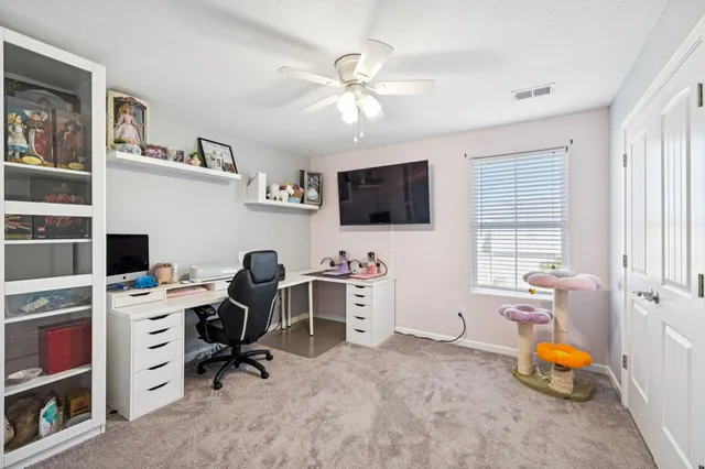 a view of a workspace with a window and a flat screen tv