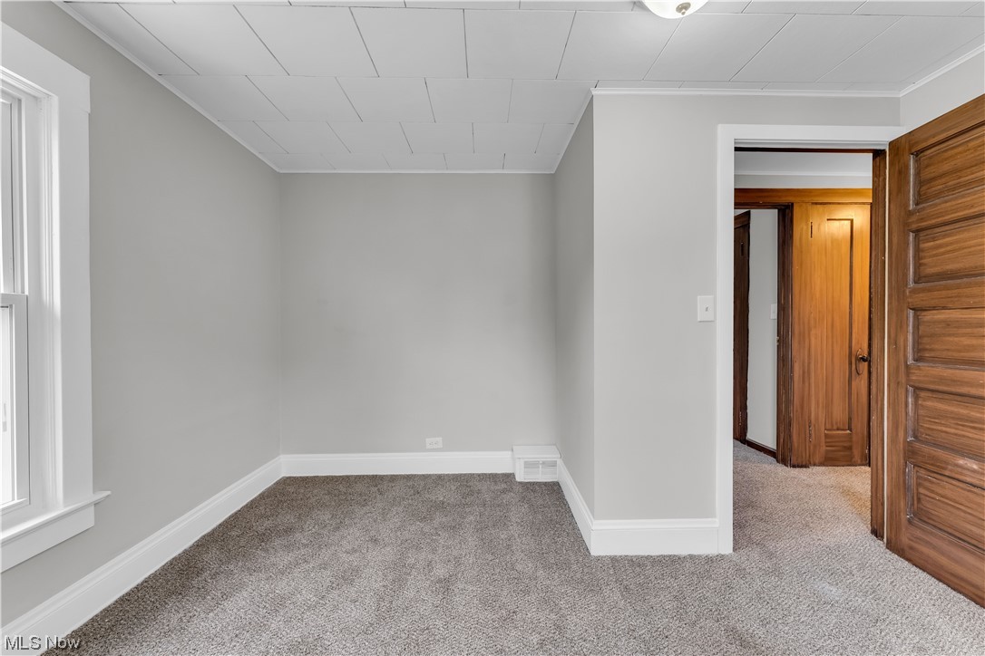 6184 Turney Road Cleveland, OH 44125 - Photo 16 of 28 Unfurnished room featuring light colored carpet and ornamental molding