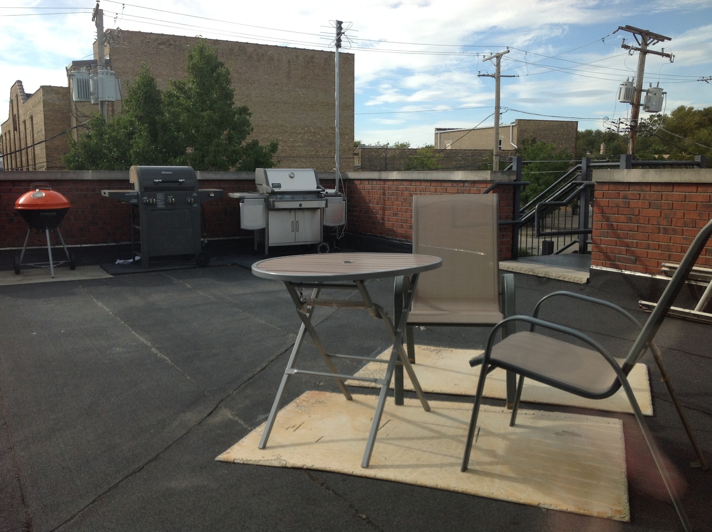 116 North Main Street, Unit 3 Wheaton, IL 60187 - Photo 8 of 12 a view of a terrace with furniture and a grill