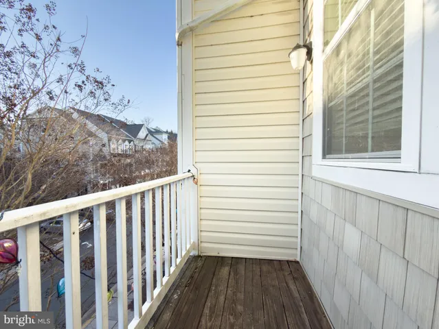 a view of a porch with wooden floor and fence