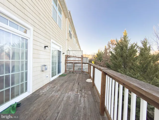 a view of balcony with wooden floor and fence