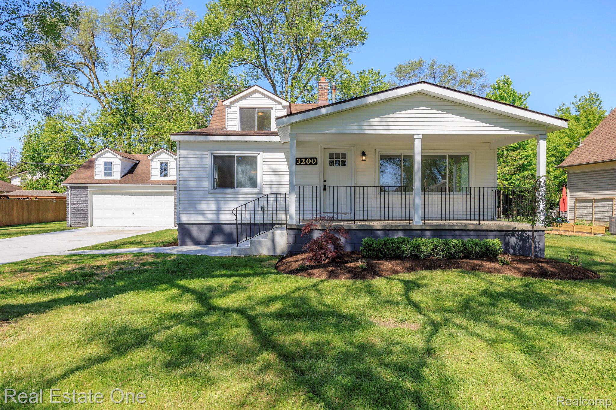3200 Hessel Avenue Rochester, MI 48307 - Photo 1 of 32 View of front of property with covered porch, a chimney, an outdoor structure, and a garage