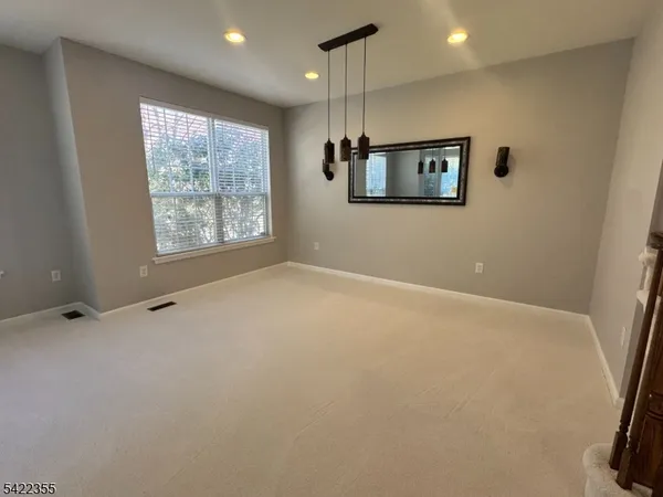 a view of an empty room with windows