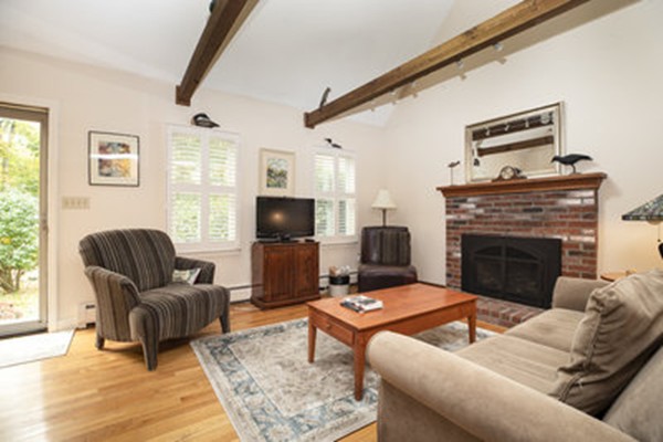 40 Allen Place, Unit 40 Scituate, MA 02066 - Photo 6 of 23 a living room with furniture a flat screen tv and a fireplace