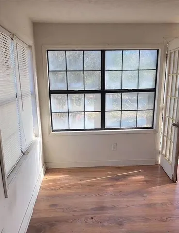 a room with gym equipment and large window