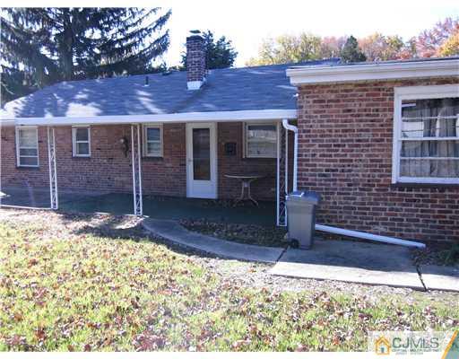 17 Gurley Road Edison, NJ 08817 - Photo 2 of 8 a view of a brick house with a yard
