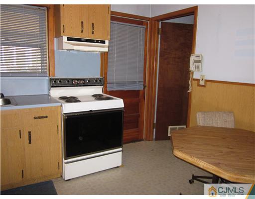 17 Gurley Road Edison, NJ 08817 - Photo 5 of 8 a kitchen with a stove and a refrigerator