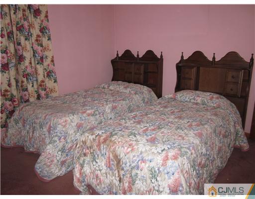 17 Gurley Road Edison, NJ 08817 - Photo 7 of 8 a bedroom with a bed and a painting on the wall