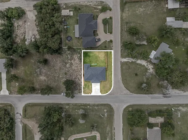 an aerial view of a house with a yard