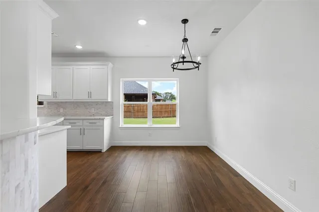 a view of a kitchen with a sink dishwasher and wooden floor
