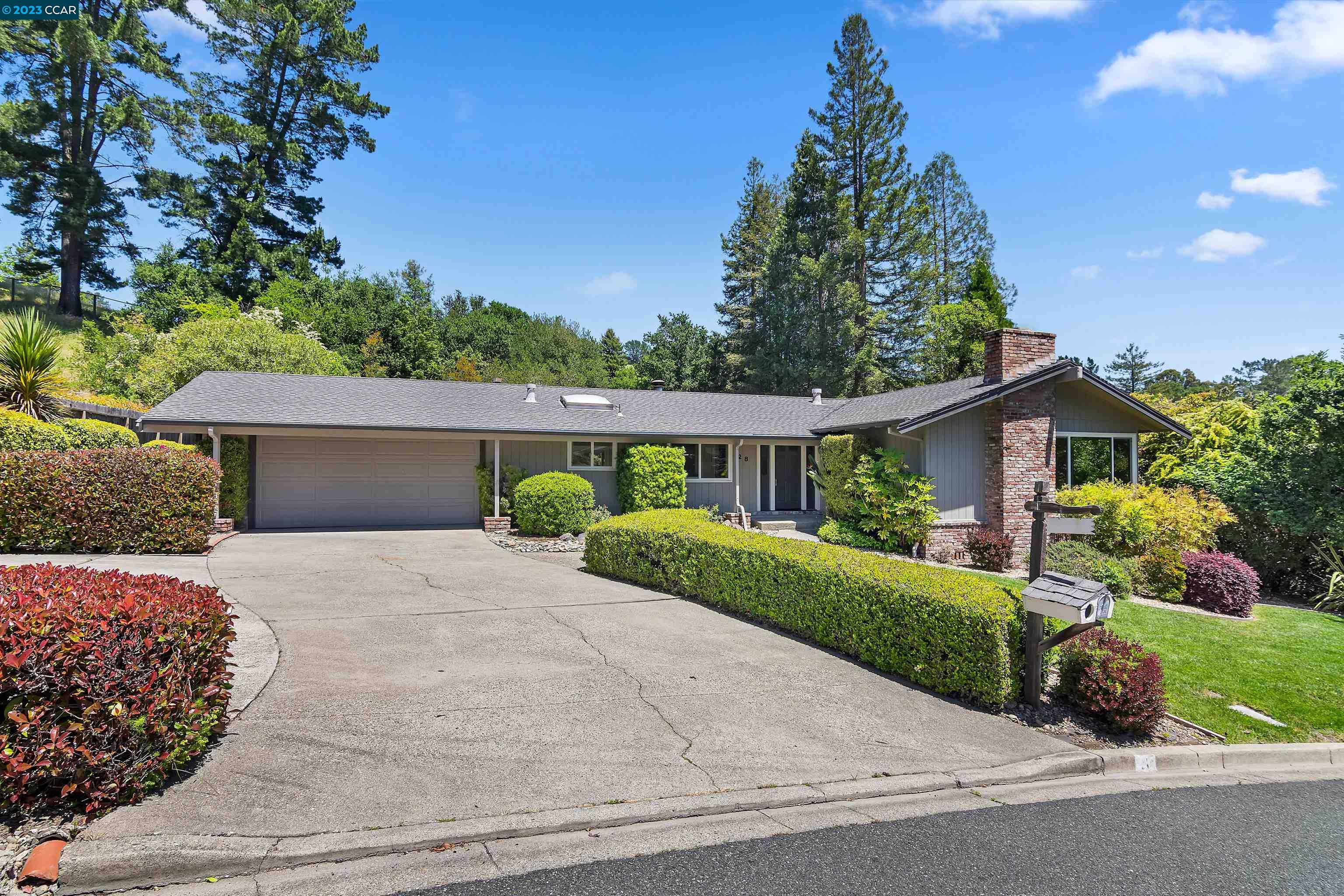 28 Ashbrook Place Moraga, CA 94556 - Photo 1 of 1 a front view of a house with a yard and garage