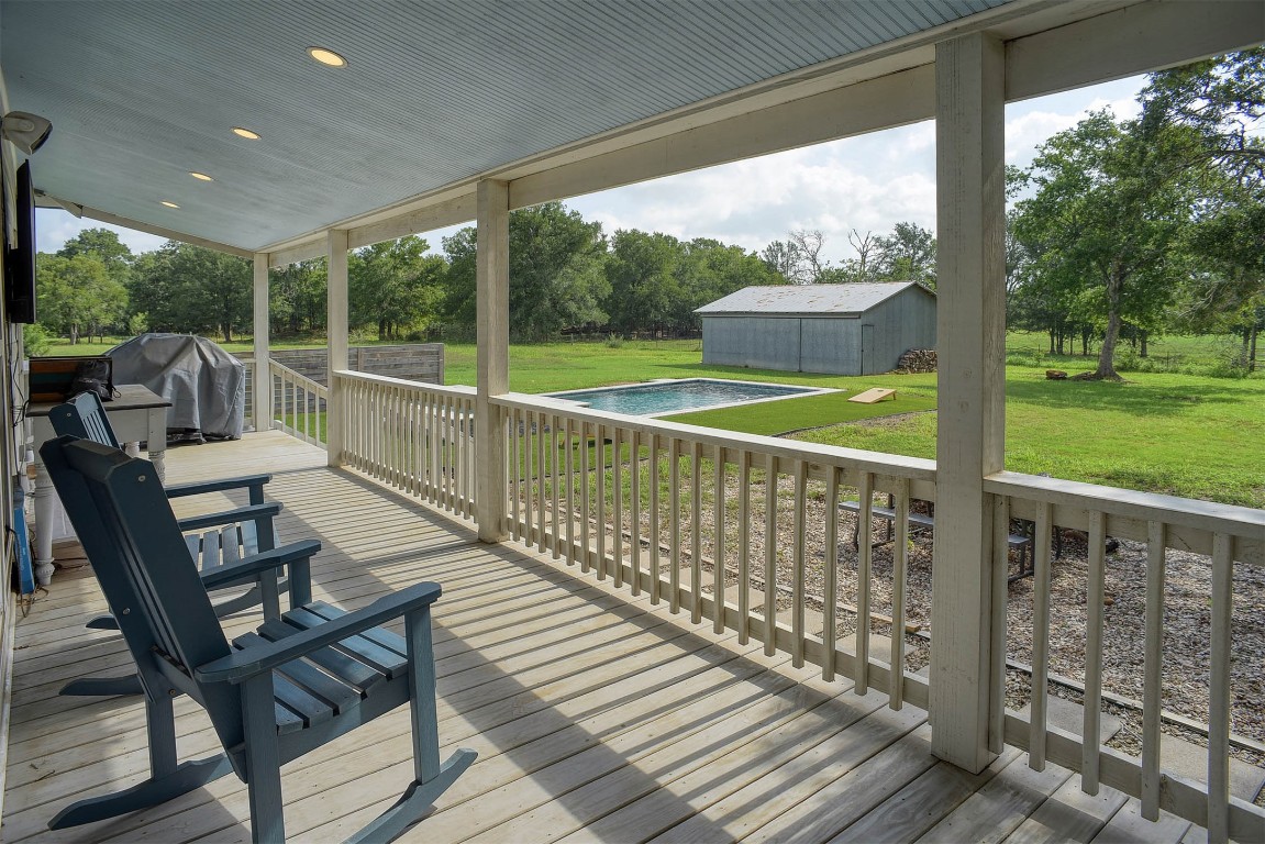 141 Grassyville Road Paige, TX 78659 - Photo 18 of 30 a view of a chairs and table on the deck