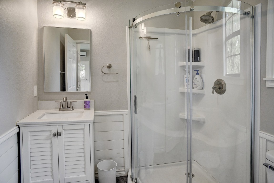 141 Grassyville Road Paige, TX 78659 - Photo 23 of 30 a bathroom with a shower sink vanity and mirror