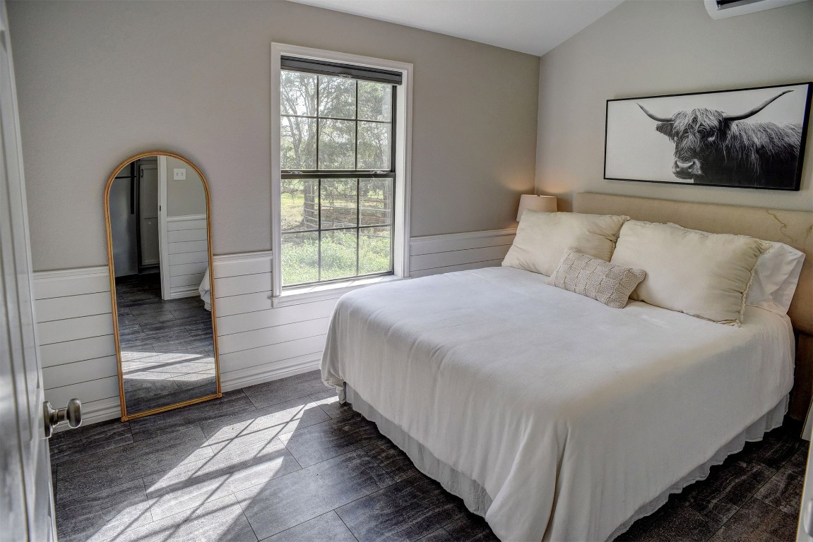 141 Grassyville Road Paige, TX 78659 - Photo 24 of 30 a bedroom with a bed and a large window