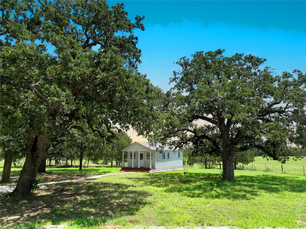 141 Grassyville Road Paige, TX 78659 - Photo 3 of 30 a front view of a house with a yard