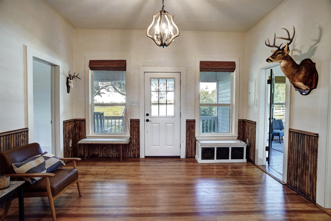 141 Grassyville Road Paige, TX 78659 - Photo 4 of 30 a view of a livingroom with furniture wooden floor and a chandelier