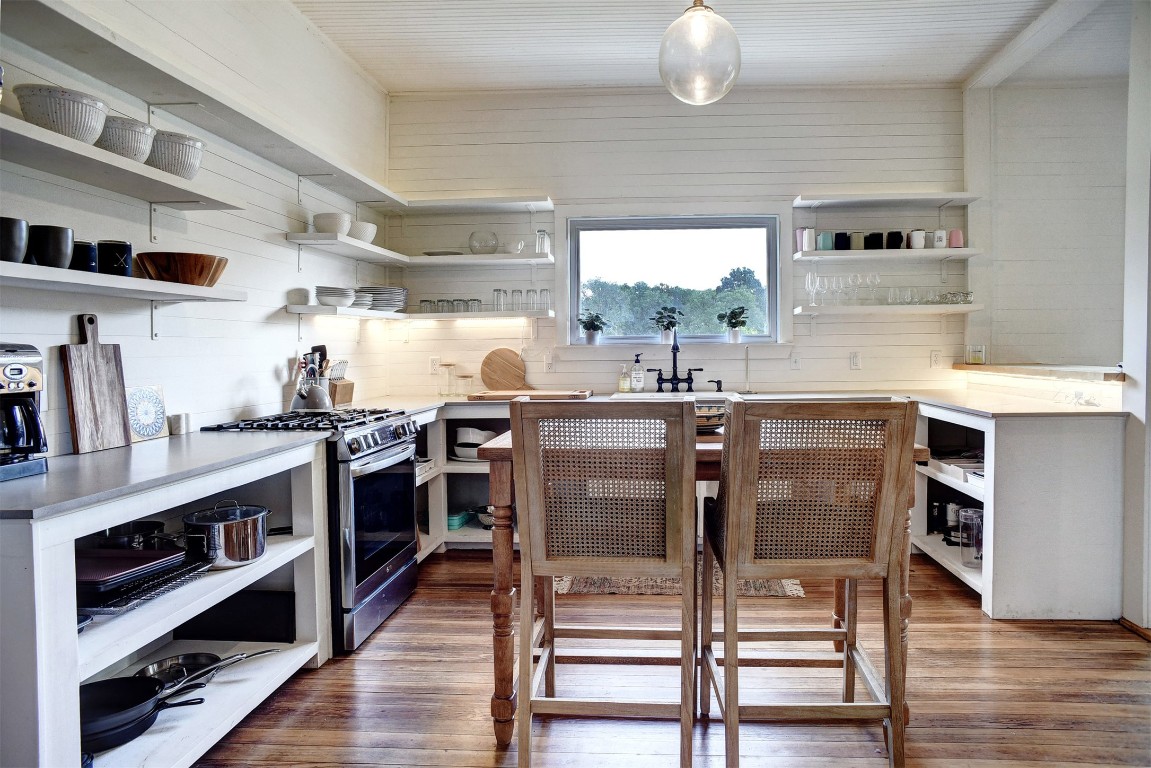 141 Grassyville Road Paige, TX 78659 - Photo 5 of 30 a kitchen with stainless steel appliances granite countertop a stove and a refrigerator