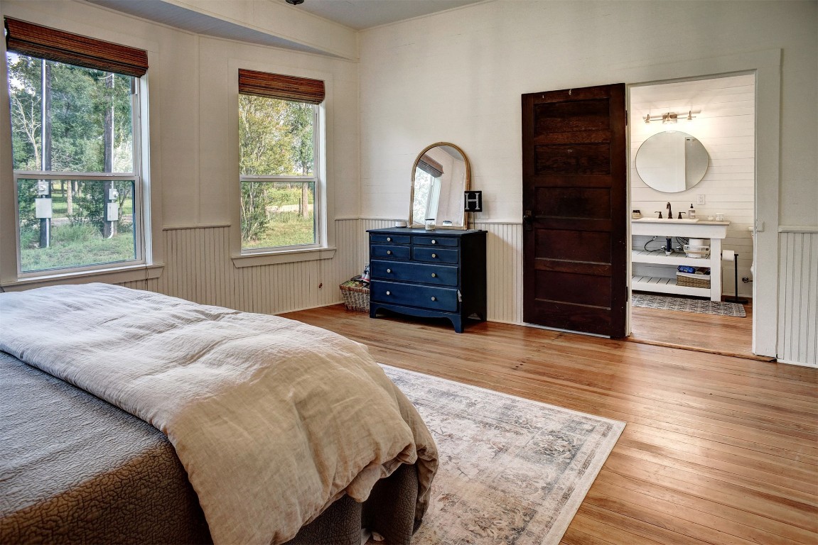 141 Grassyville Road Paige, TX 78659 - Photo 10 of 30 a bedroom with a bed and wooden floor