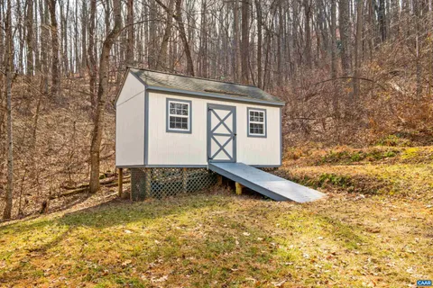 a view of balcony with wooden floor and fence