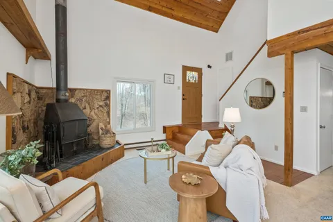 a living room with furniture and a floor to ceiling window