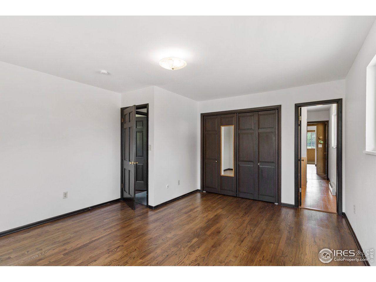 5758 Rustic Knolls Drive Boulder, CO 80301 - Photo 15 of 28 a view of an empty room with wooden floor
