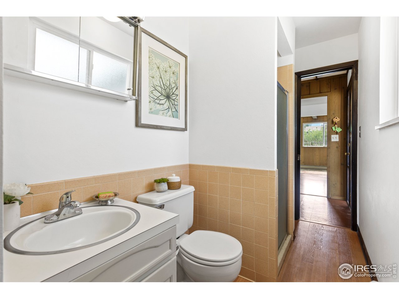 5758 Rustic Knolls Drive Boulder, CO 80301 - Photo 16 of 28 a bathroom with a sink mirror vanity and toilet