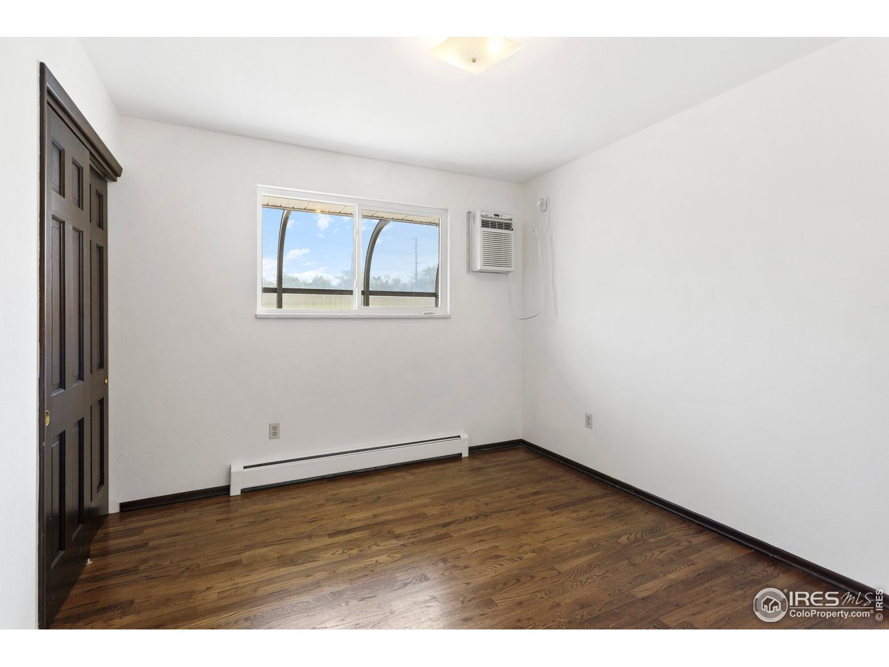 5758 Rustic Knolls Drive Boulder, CO 80301 - Photo 17 of 28 a view of an empty room with wooden floor