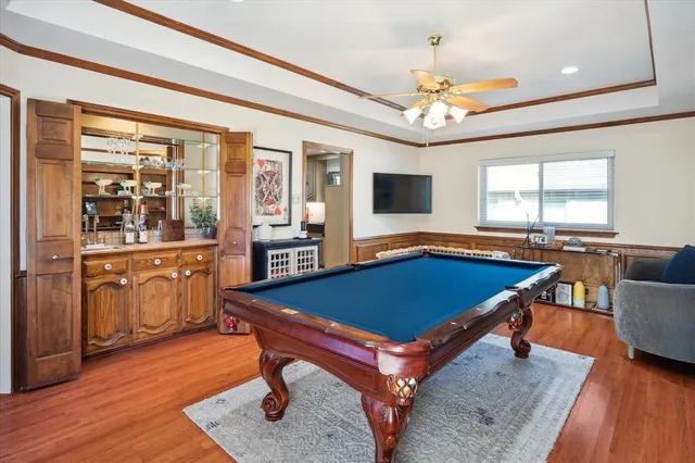 a living room with furniture a flat screen tv and kitchen view