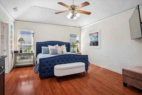 a bedroom with a bed and wooden floor