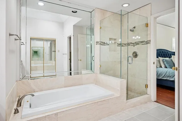 a bathroom with a bathtub and a shower