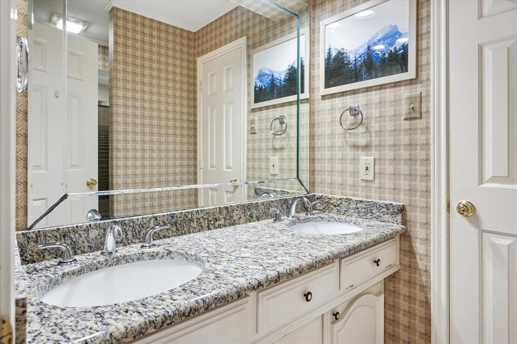 4302 Brooktree Lane Dallas, TX 75287 - Photo 19 of 23 a bathroom with a granite countertop sink and a mirror