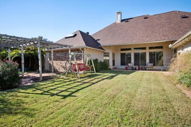 a view of a house with floor to ceiling windows and a basket ball poll