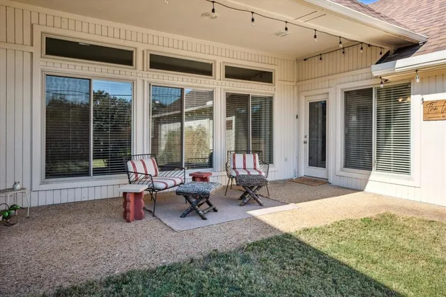 a view of a backyard with sitting area and garden