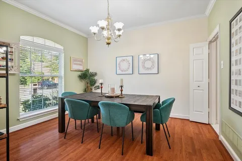 a view of a dining room with furniture wooden floor and a chandelier