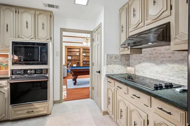 a kitchen with granite countertop a stove and a sink