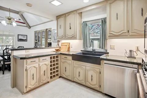 a kitchen with stainless steel appliances granite countertop a sink stove and cabinets