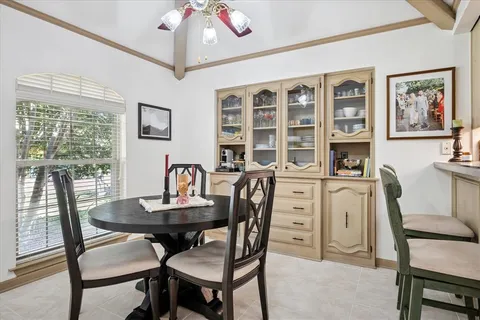 a dining room with furniture and window