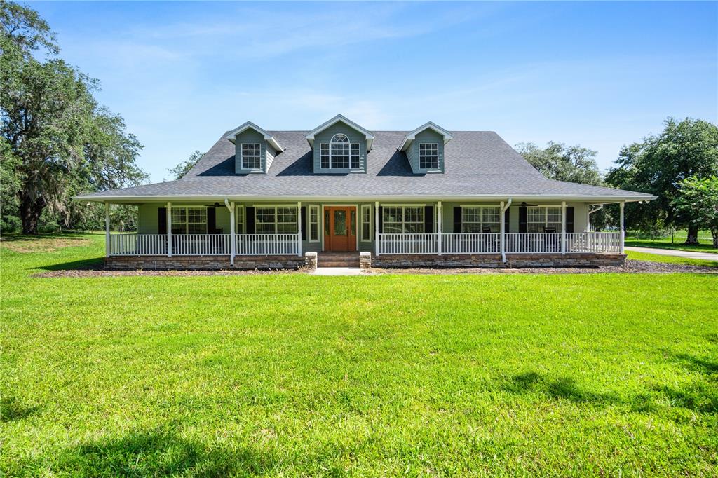 9045 Lake Hatchineha Road Kissimmee, FL 34759 - Photo 3 of 47 front view of a house with a yard