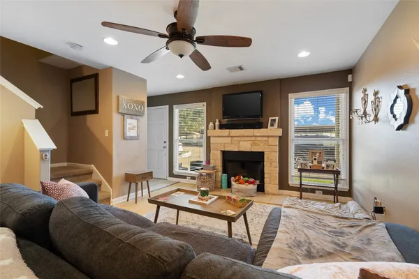 a living room with furniture a fireplace and a flat screen tv