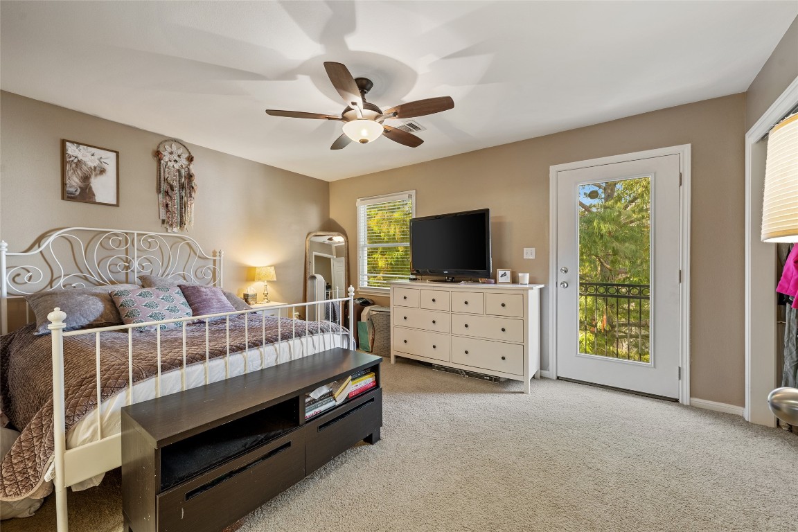 6900 East Riverside Drive, Unit 12 Austin, TX 78741 - Photo 21 of 27 a bedroom with furniture and flat screen tv