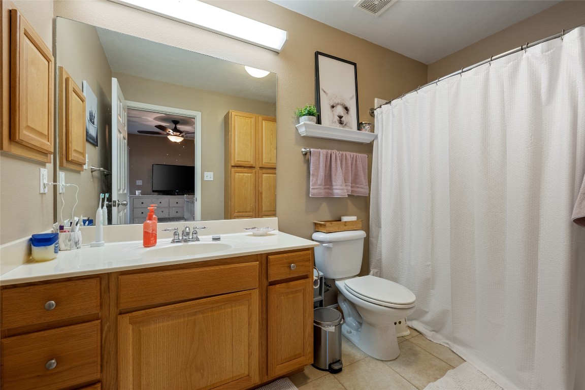 6900 East Riverside Drive, Unit 12 Austin, TX 78741 - Photo 24 of 27 a bathroom with a sink a toilet and mirror