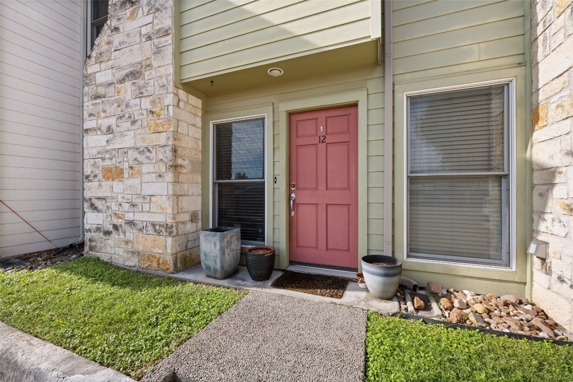 6900 East Riverside Drive, Unit 12 Austin, TX 78741 - Photo 3 of 27 a front view of a house with a garden