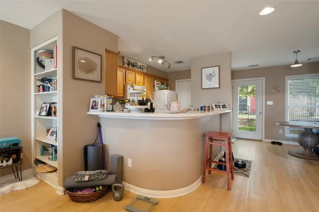 a room with a table chairs and a wooden floor