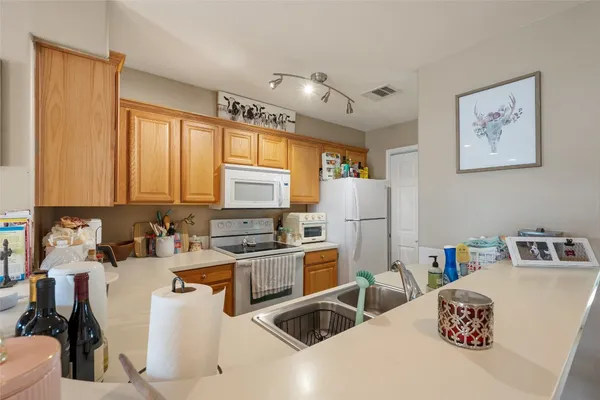 a kitchen with a sink a stove and a refrigerator