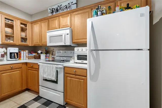 a white refrigerator freezer sitting inside of a kitchen