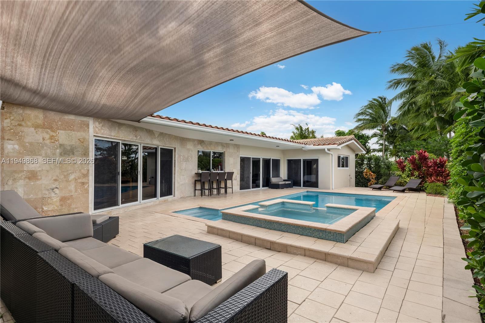 1155 South Biscayne Point Road Miami Beach, FL 33141 - Photo 20 of 23 a view of a house with backyard patio and swimming pool