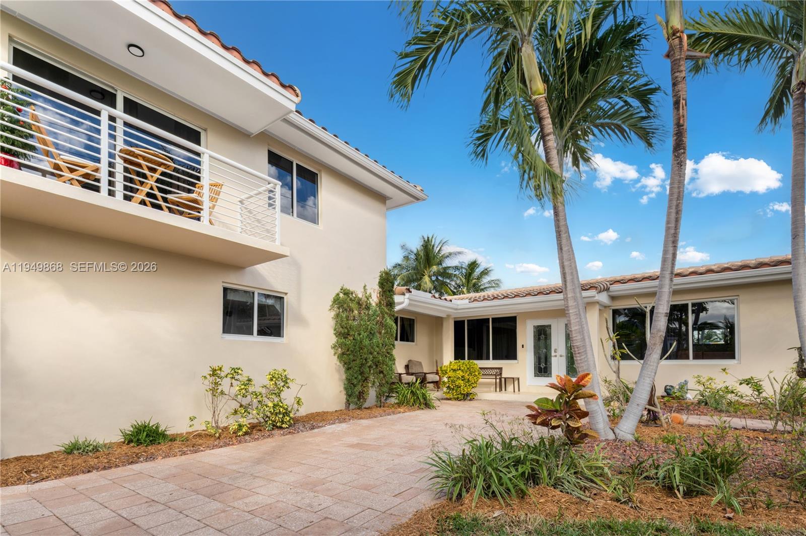 1155 South Biscayne Point Road Miami Beach, FL 33141 - Photo 21 of 23 a front view of a house with patio furniture and potted plants
